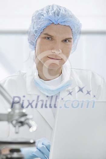 Man working by a laptop in a laboratory Man working by a laptop in a laboratory