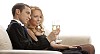 Couple toasting on the sofa