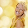 Beuatiful woman smiling in golden enviroment