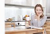 Woman sitting at the kitchen table reading