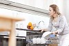 Woman in the kitchen dealing with dishes