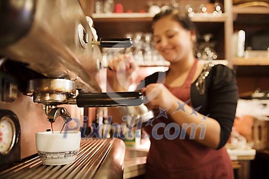 Waitress making coffee with machine Waitress making coffee with machine