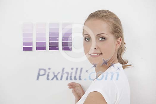 Woman choosing a paint colour for the wall Woman choosing a paint colour for the wall