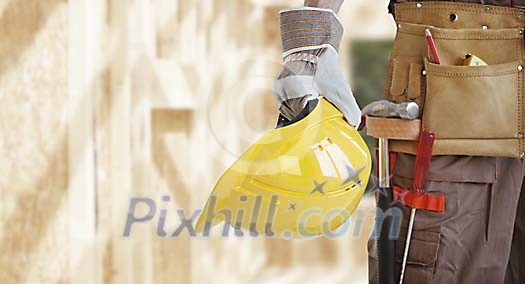 Hand with helmet on the building site Hand with helmet on the building site