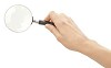 Clipped female hand with magnifying glass