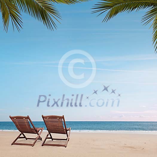 Two deckchairs on an empty beach