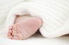 Baby foot under the blanket