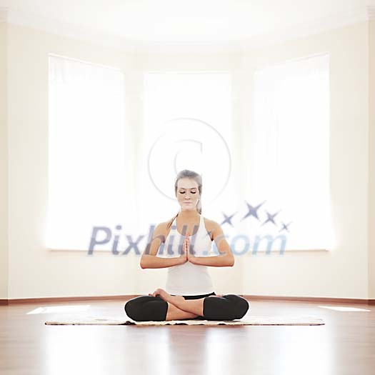 Woman meditating with hands on her chest Woman meditating with hands on her chest