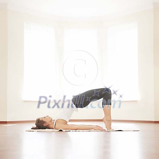 Woman stretching on the floor Woman stretching on the floor
