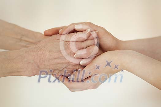 Young hands holding old hands Young hands holding old hands