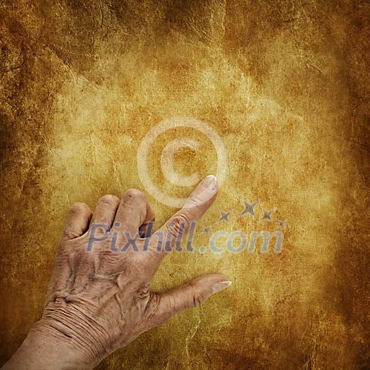 Old hand pointing on an old paper Old hand pointing on an old paper