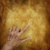 Old hand pointing on an old paper