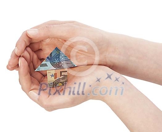 Clipped hands holding a house made of money Clipped hands holding a house made of money