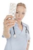 Nurse/doctor holding a leaf of pills to the camera