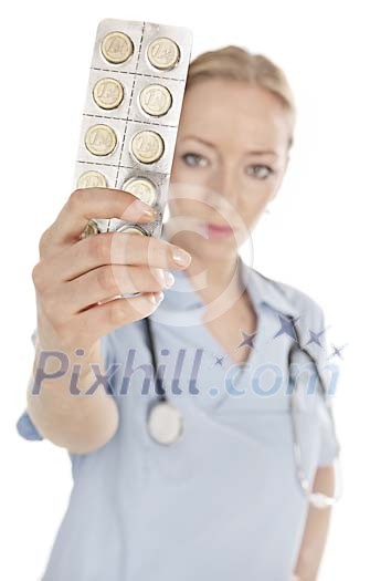 Female nurse holding a leaf of coin-pills Female nurse holding a leaf of coin-pills