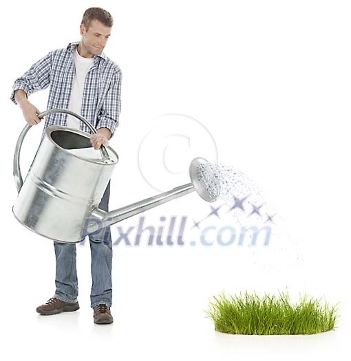Man watering grass with giant watering can Man watering grass with giant watering can