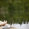 Male resting next to his laptop on dock