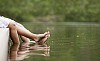 Male and female feet touching each other on the dock