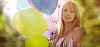 Smiling girl with balloons in hand