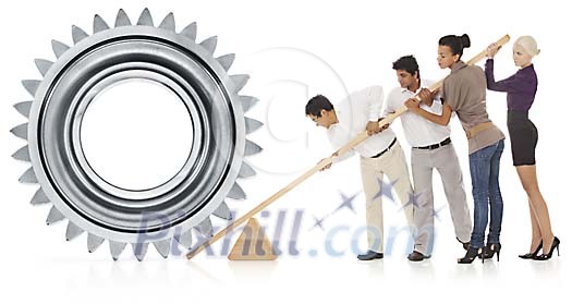 Multicultural group working together moving a giant cog wheel Multicultural group working together moving a giant cog wheel