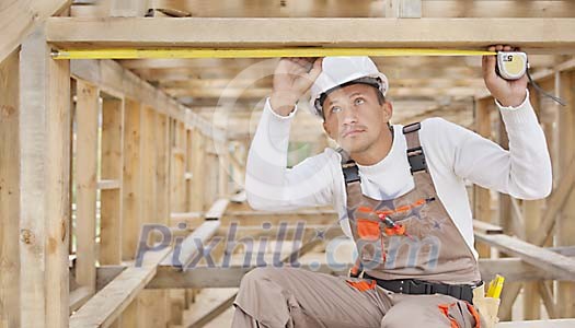 Constuction worker measuring Constuction worker measuring
