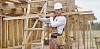 Constuction worker carrying timber