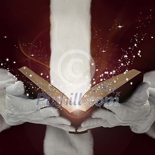 Santa Claus holding an open book releasing the stars Santa Claus holding an open book releasing the stars