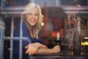 Woman smiling through the wine bar window