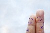 Fingers with faces holding and smiling