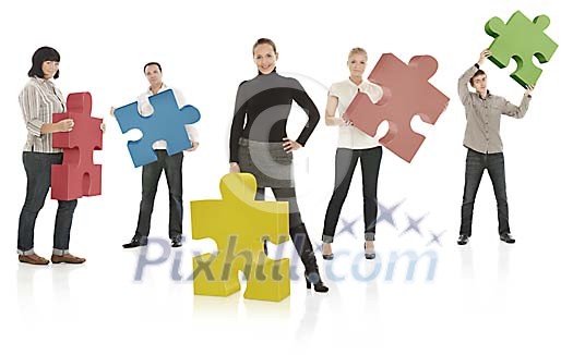 Team members holding puzzle pieces Team members holding puzzle pieces