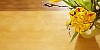 Vase of yellow tulips and pussy willow on a wooden table