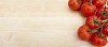 Group of tomatoes on wooden background