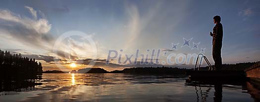 Man enjoying the sunset by the lake