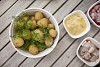 Boiled potatoes with dill and herring on table outside