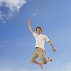 Male jumping on blue sky