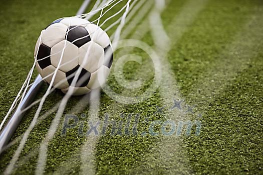 Soccer ball inside goal Soccer ball inside goal
