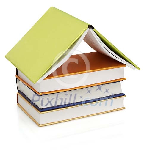 Isolated books piled to form a house Isolated books piled to form a house