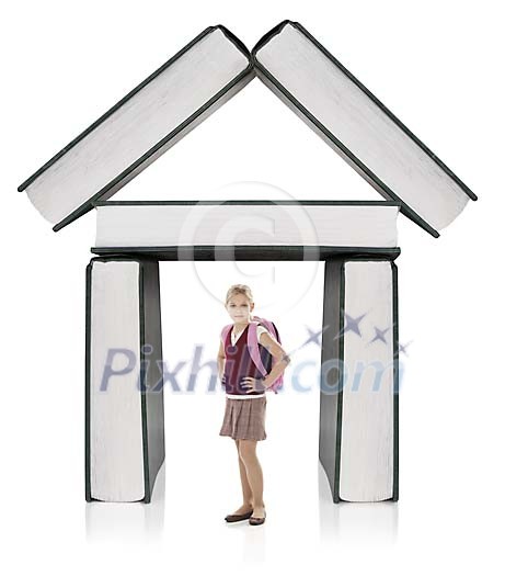 Isolated girl standing in front of building made out of books Isolated girl standing in front of building made out of books