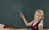 Girl drawing lamp on blackboard