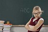 Girl student standing in front of blackboard