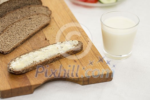 Rye bread with butter and a glass of milk Rye bread with butter and a glass of milk