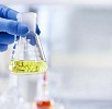 Hand holding a measuring glass