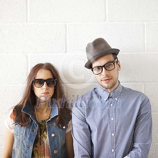 Man and a woman standing by the wall Man and a woman standing by the wall