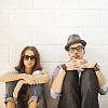 Couple sitting by the wall