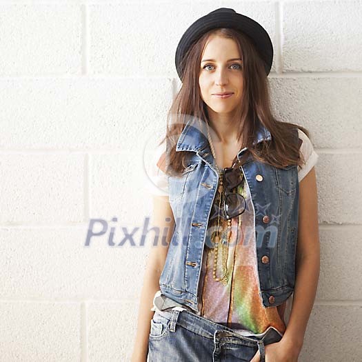 Trendy woman standing by the wall Trendy woman standing by the wall