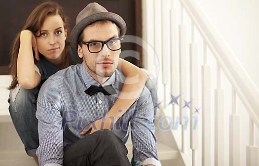 Hipster couple sitting on the stairs Hipster couple sitting on the stairs