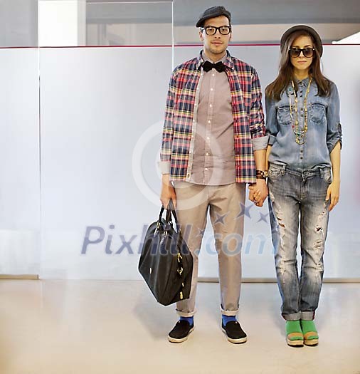 Trendy man and woman standing in the corridor Trendy man and woman standing in the corridor