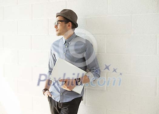 Trendy man thinking by the wall Trendy man thinking by the wall