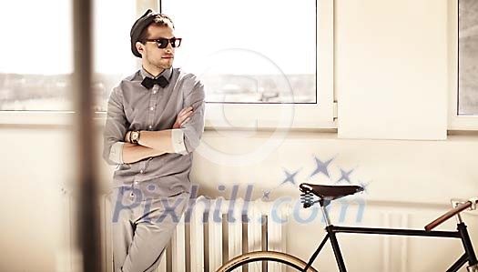 Trendy man sittig on a radiator Trendy man sittig on a radiator