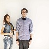 Couple posing by the wall